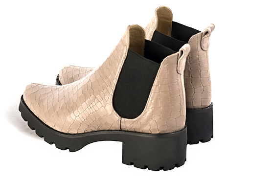 Tan beige and matt black women's ankle boots, with elastics. Round toe. Low rubber soles. Rear view - Florence KOOIJMAN